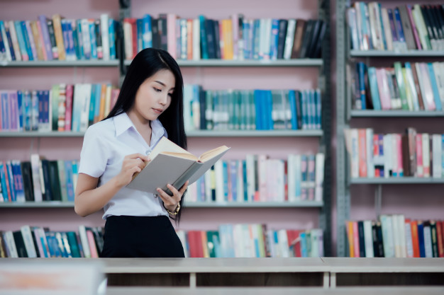 portrait-young-student-reading-book-library_1150-10557.jpg