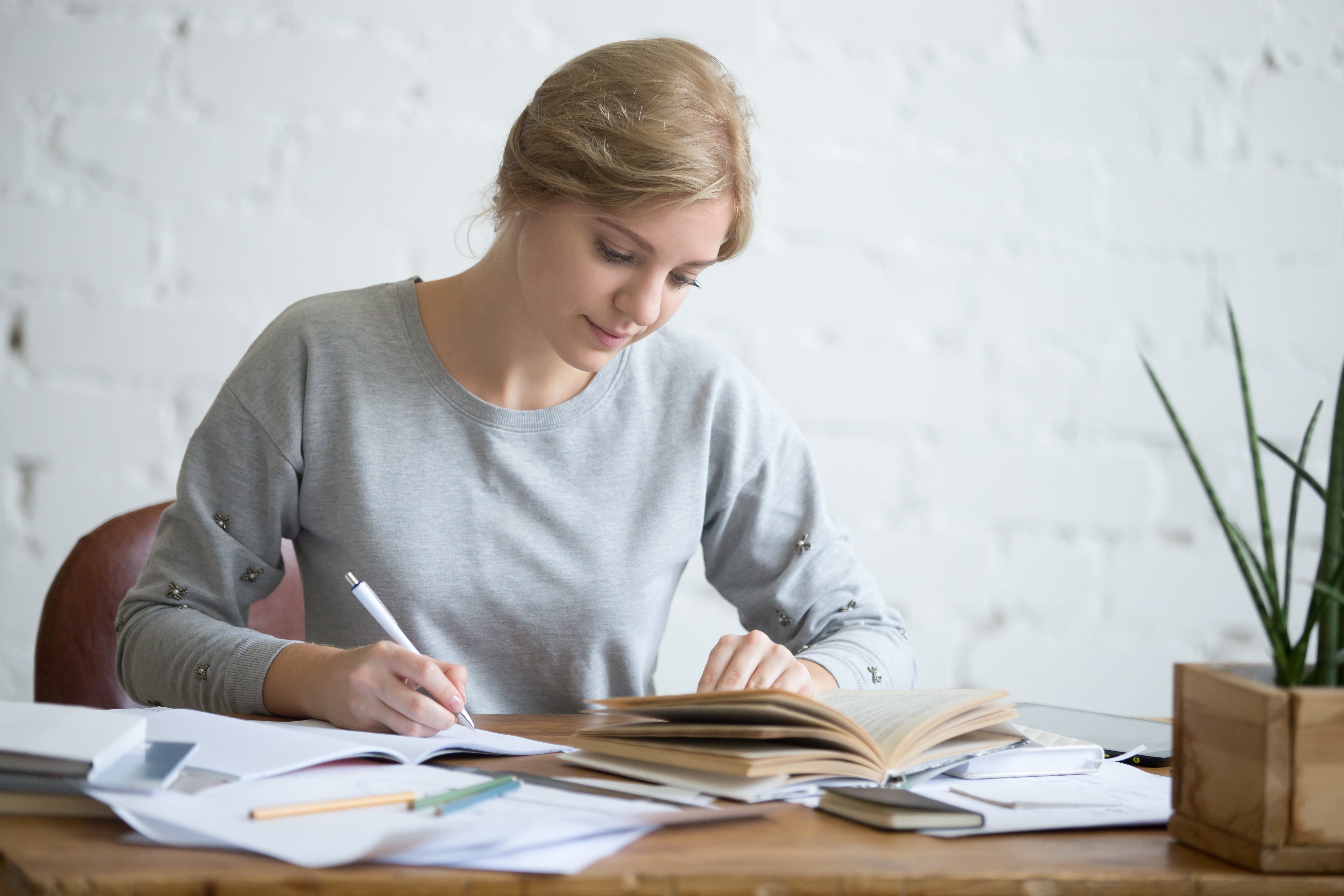 student-female-performing-written-task-copybook-min.jpg